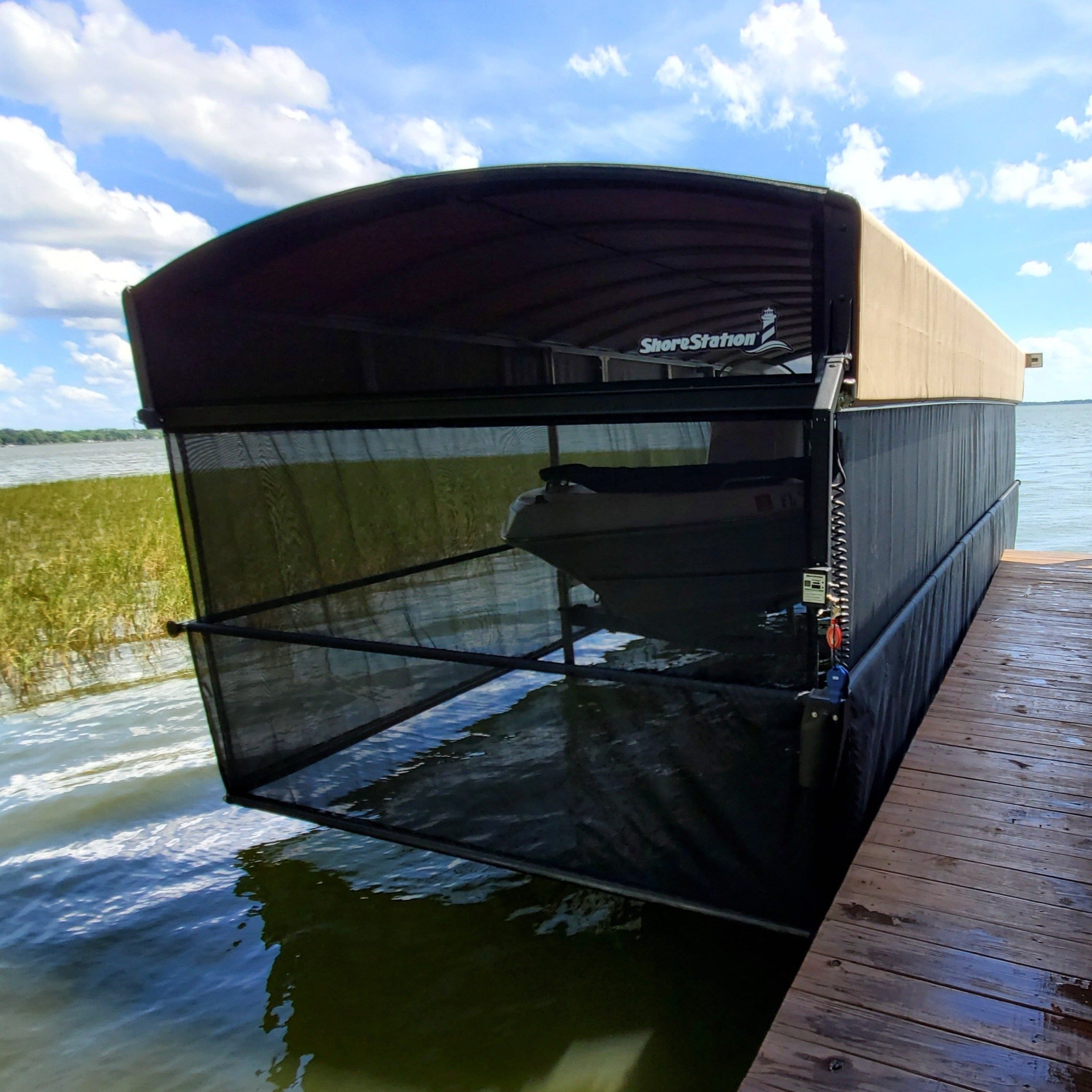 Shore Station revolution canopy cover with ShoreScreen side curtain on a freestanding boat lift