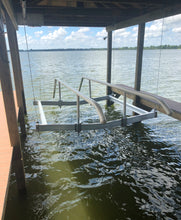 Pontoon or tritoon boat lift rail cradle kit in a boathouse